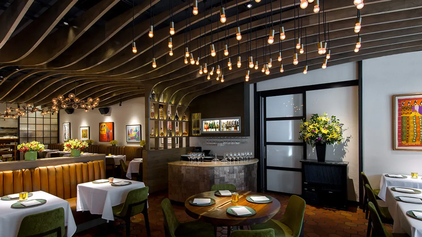 Elegant dining room interior at Atelier Chicago with stylish decor and lighting.