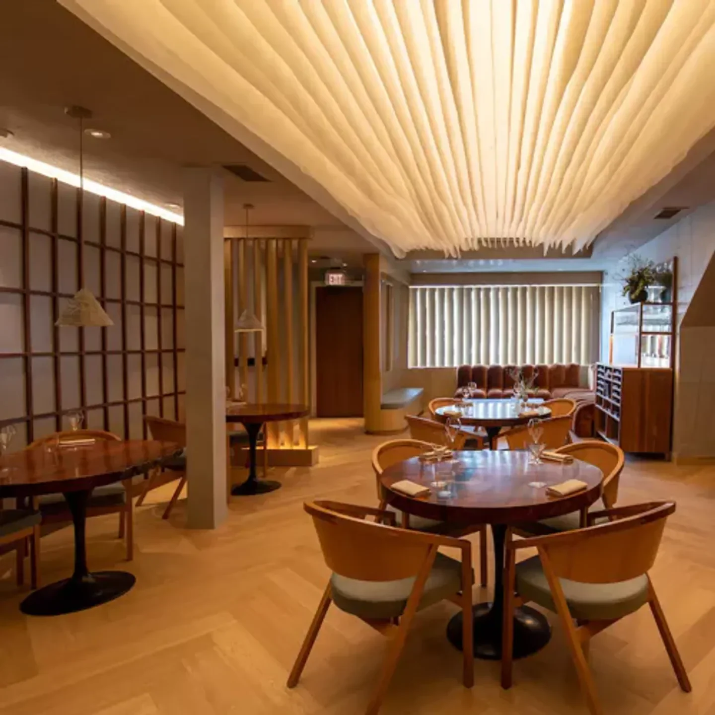 Interior of Atelier Crenn restaurant in San Francisco, featuring elegant dining tables.
