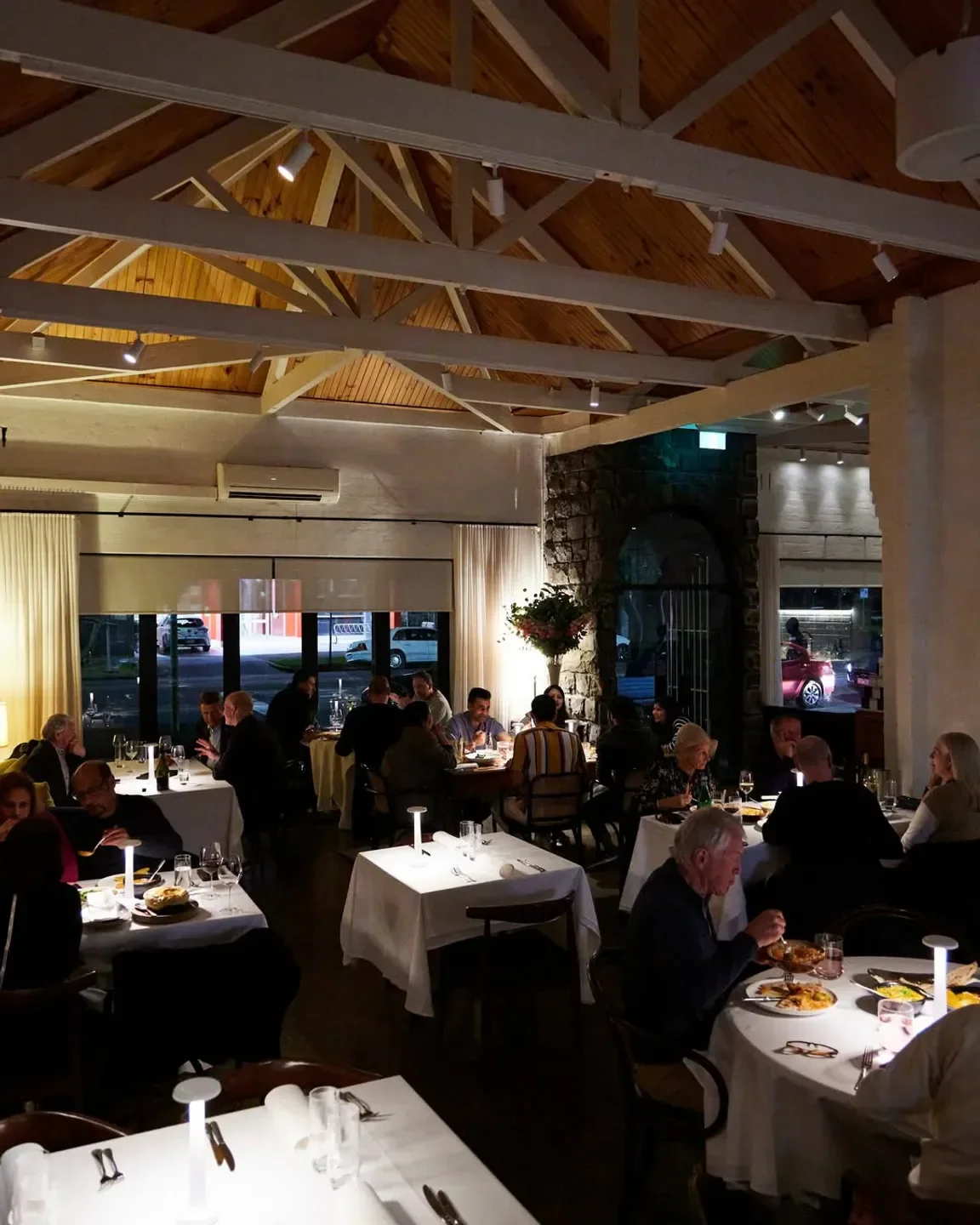 Dining room at Atta Restaurant, Melbourne, with elegant lighting and patrons enjoying their meals.