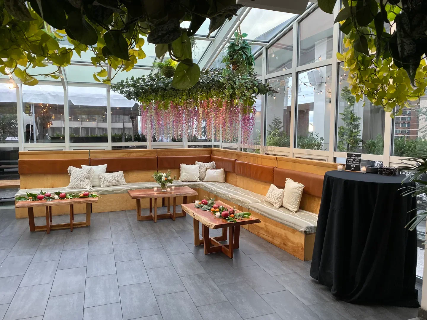 Cozy seating at Attico Rooftop in Philadelphia, featuring floral decor and city views.