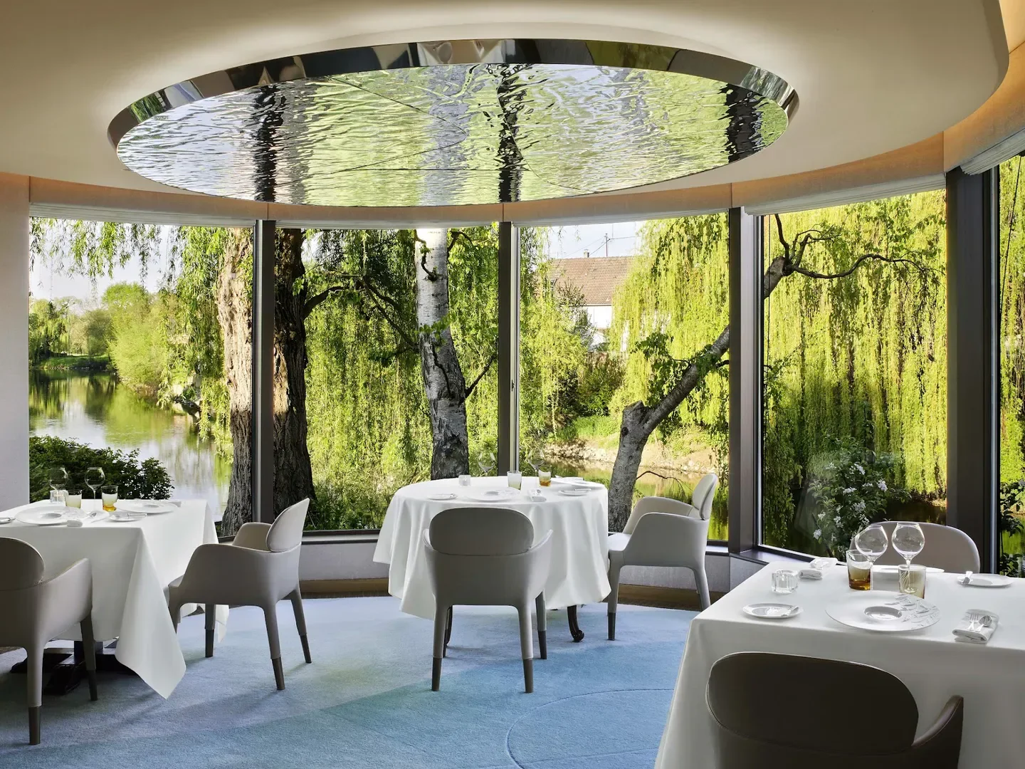 Dining room at Auberge de l'Ill in Strasbourg, with serene views of the surrounding nature