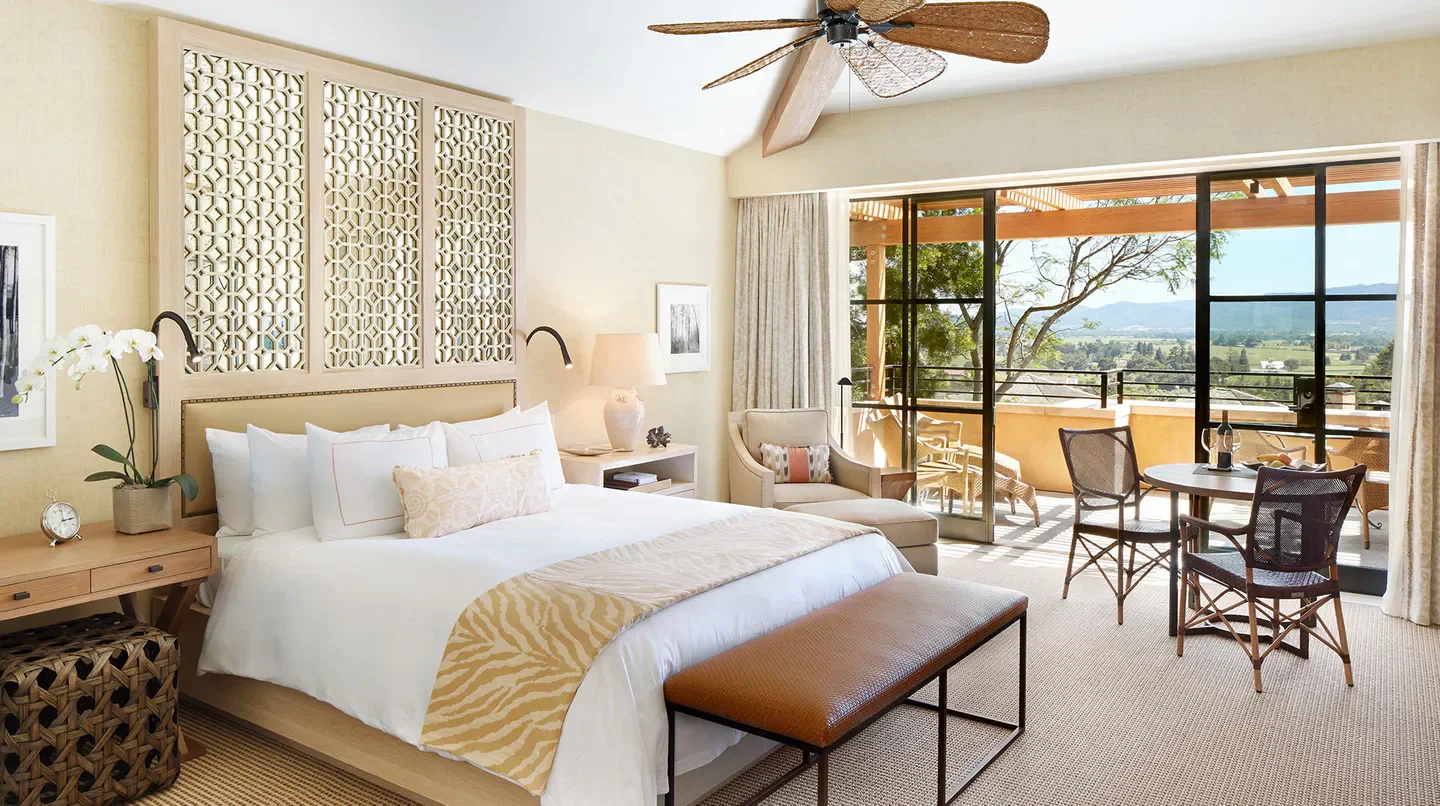 Spacious bedroom with a balcony overlooking Napa Valley at Auberge du Soleil resort