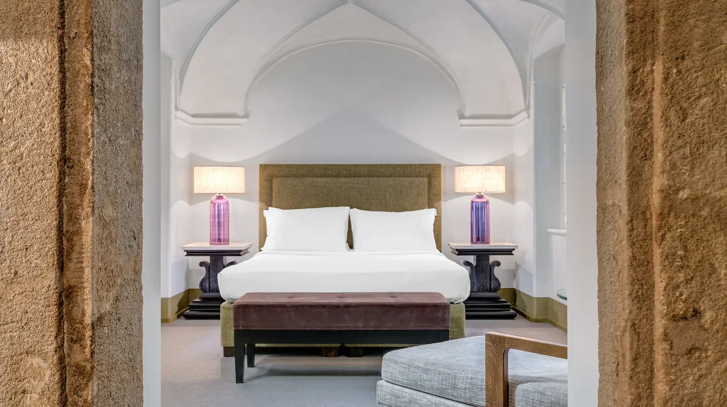 Elegant bedroom at Augustine, A Luxury Collection Hotel in Prague with arched ceiling