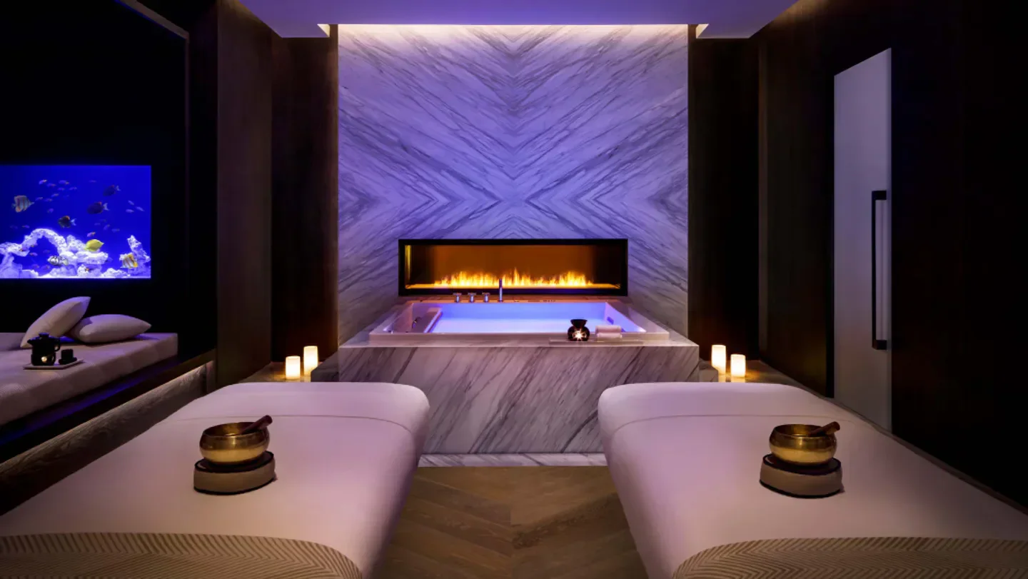 Serene spa interior at AWAKEN Wellness at Atlantis The Royal in Dubai, featuring a fireplace.