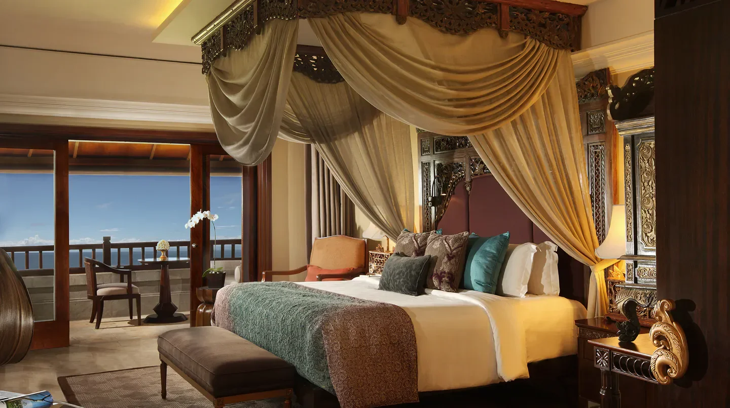 Luxury bedroom at AYANA Resort Bali with ocean view from the balcony