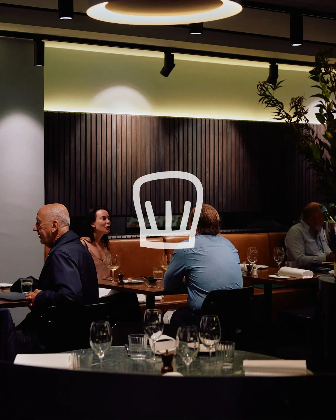 Interior dining at Bacash restaurant in Melbourne with guests enjoying a meal