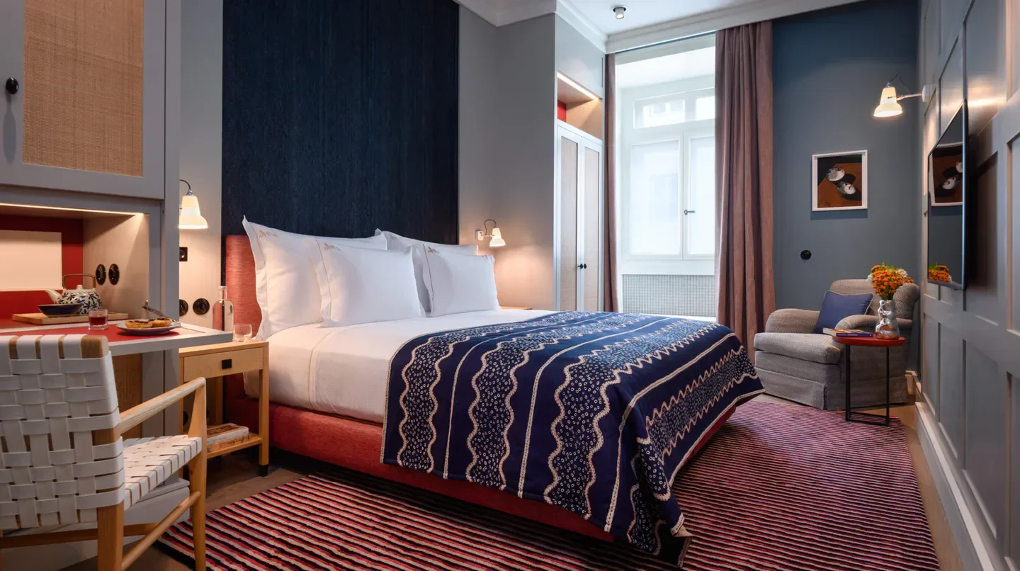 Cozy bedroom at Bairro Alto Hotel in Lisbon with stylish decor and inviting ambiance.