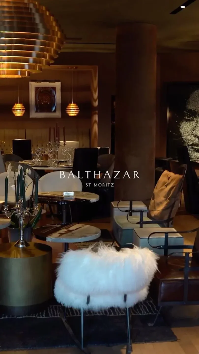 Interior of Balthazar restaurant in St. Moritz with stylish furniture and lighting.