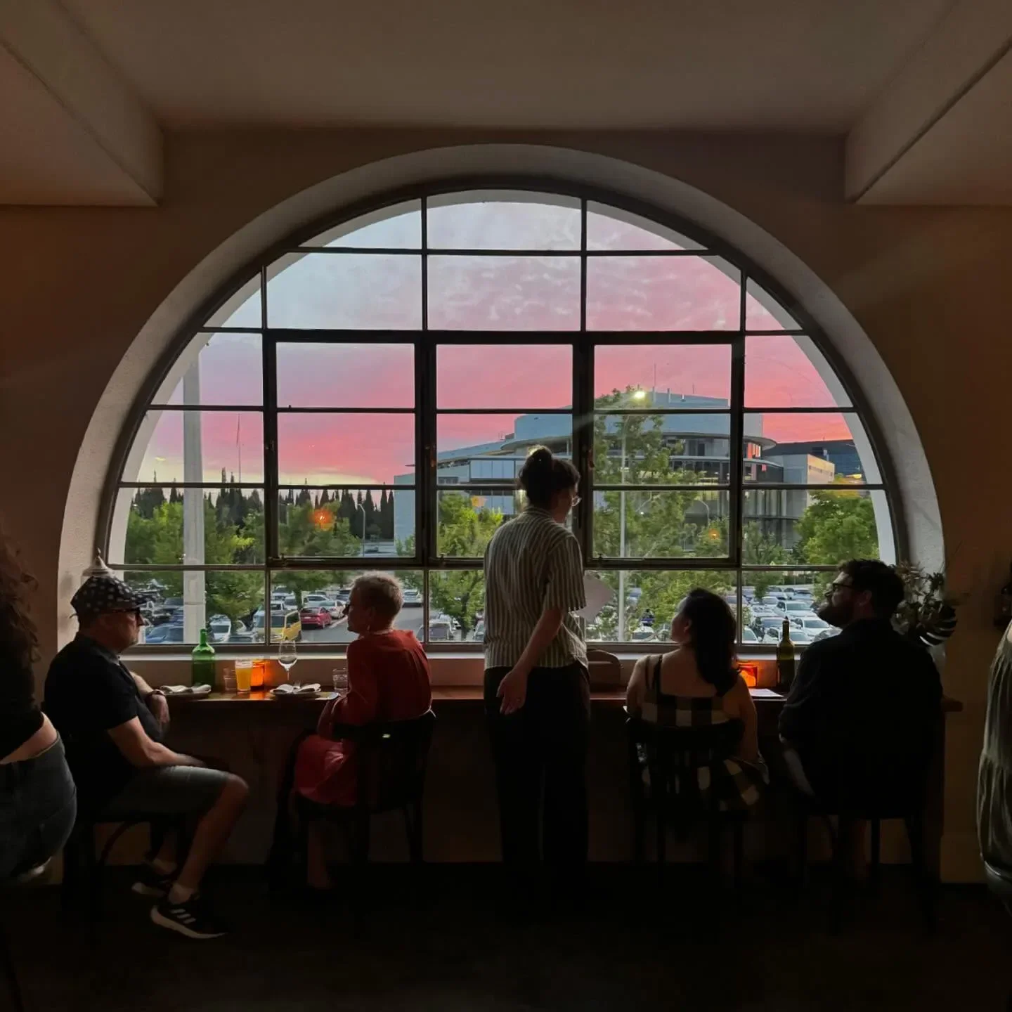 Patrons enjoying a sunset view at Bar Rochford restaurant in Canberra, Australia.