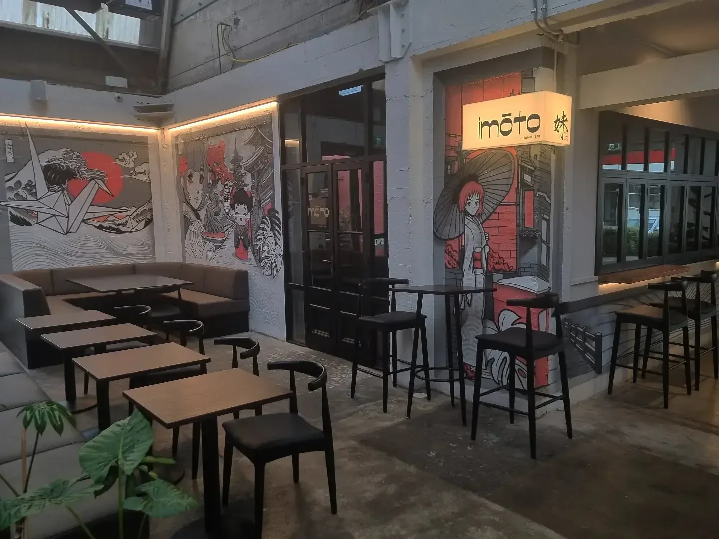 Interior of Bar Yoku in Christchurch, featuring stylish seating and Japanese-inspired murals.