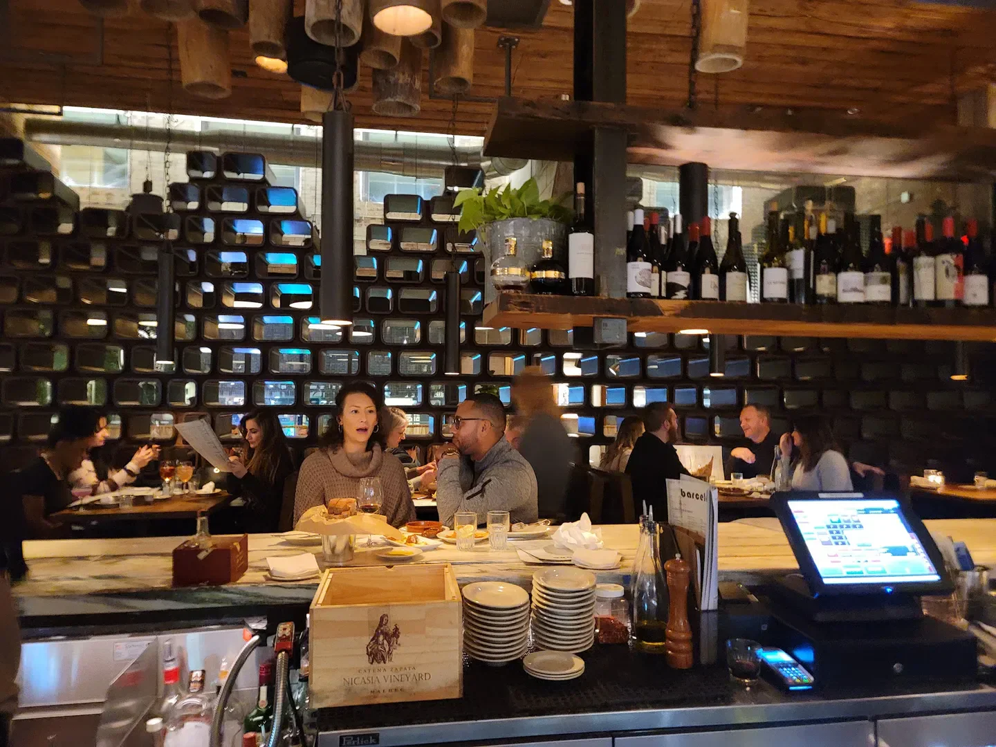 Interior of Barcelona Wine Bar - Raleigh with patrons at the bar in Raleigh, North Carolina