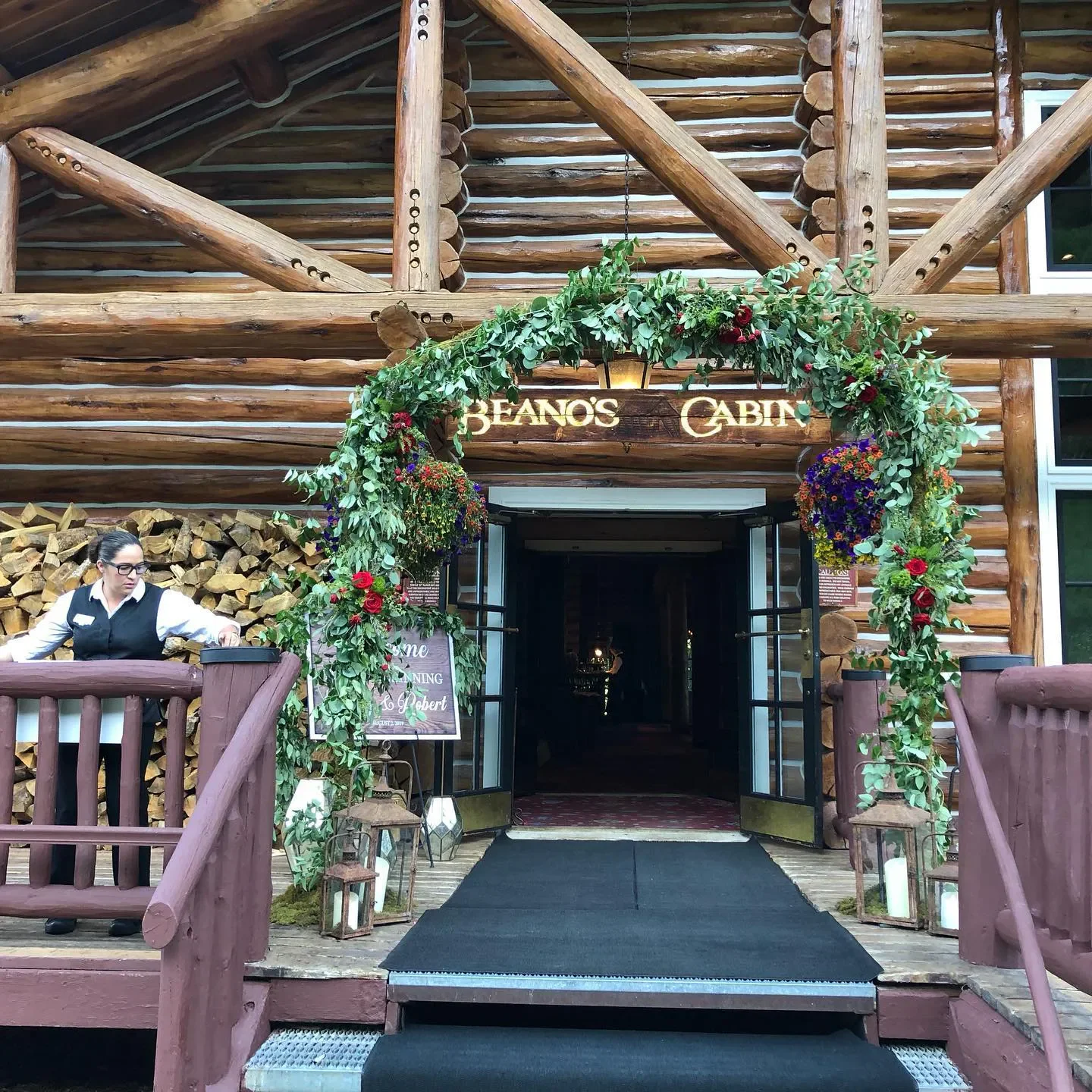 Entrance to Beano's Cabin restaurant in Vail, Colorado, with floral archway and rustic design.
