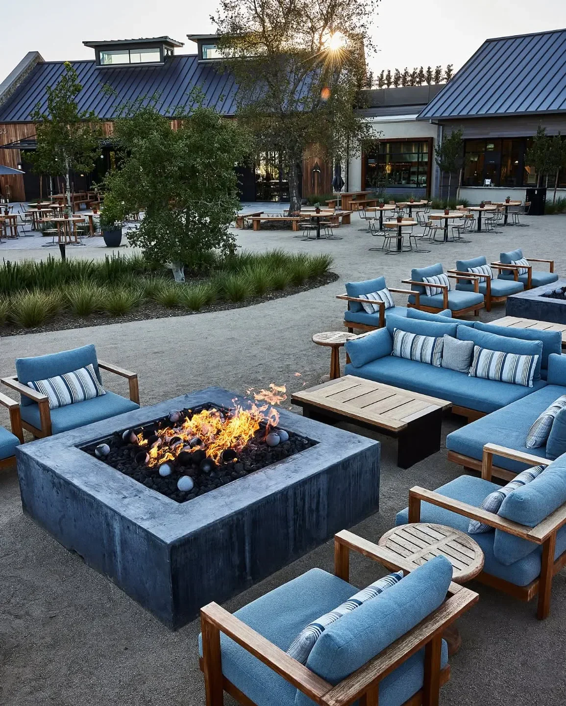 Outdoor seating area at Bear restaurant in Napa Valley with fire pit and blue furniture