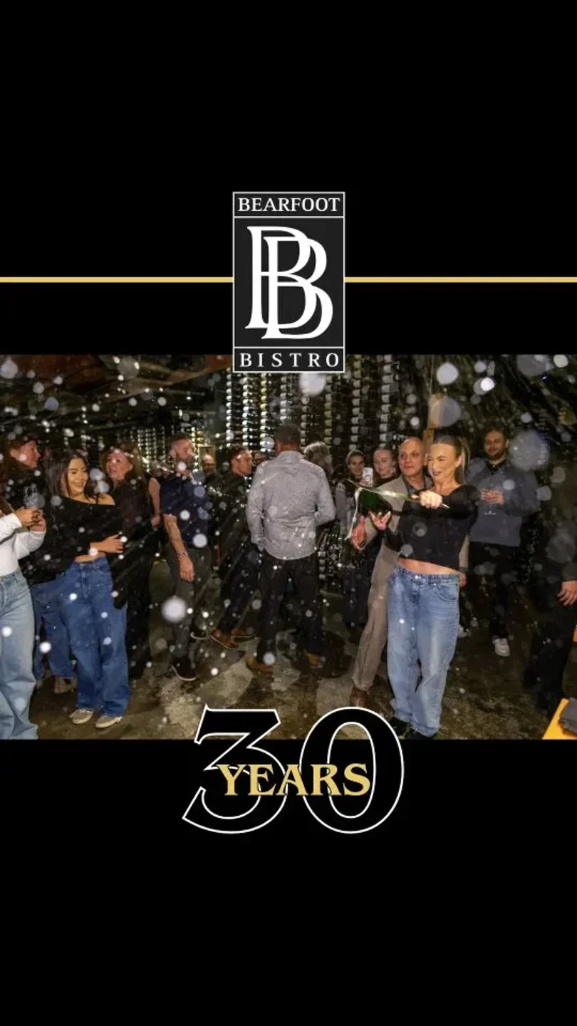 Celebration at Bearfoot Bistro in Whistler with people and champagne bottle
