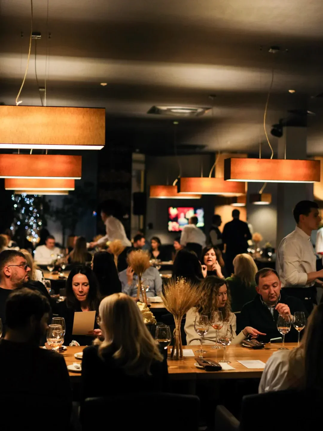 Cozy restaurant interior at Beef Meat & Wine in Kyiv, with patrons dining.