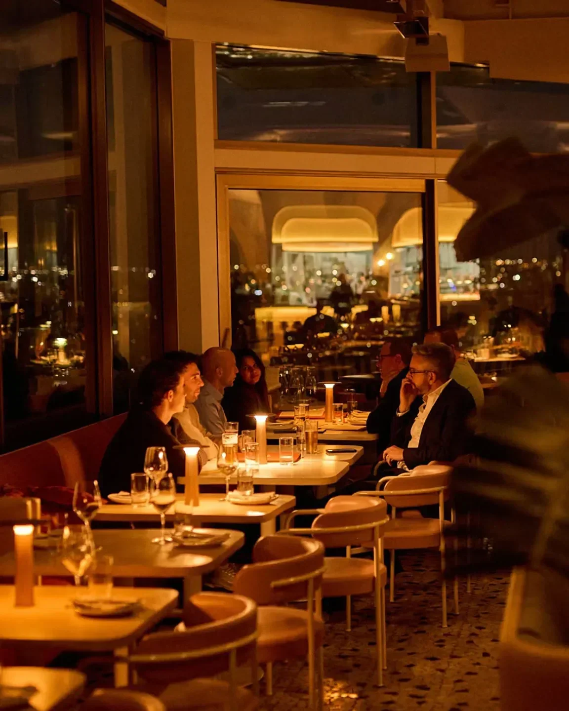 Beverly restaurant in Melbourne with diners enjoying a candlelit dinner, city views.