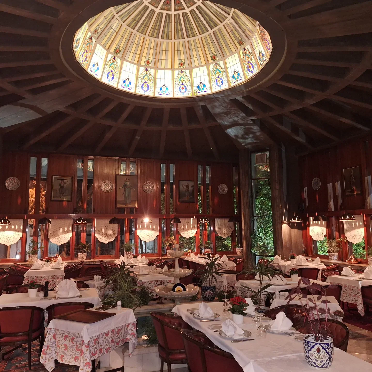 Elegant dining area at Beyti restaurant in Istanbul, featuring a beautiful stained glass dome.