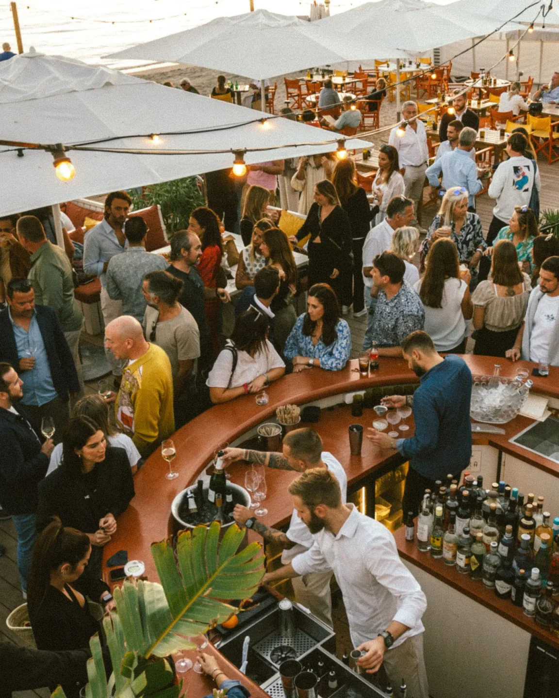 Guests enjoying drinks and the atmosphere at Bijou Plage restaurant in Cannes during daytime
