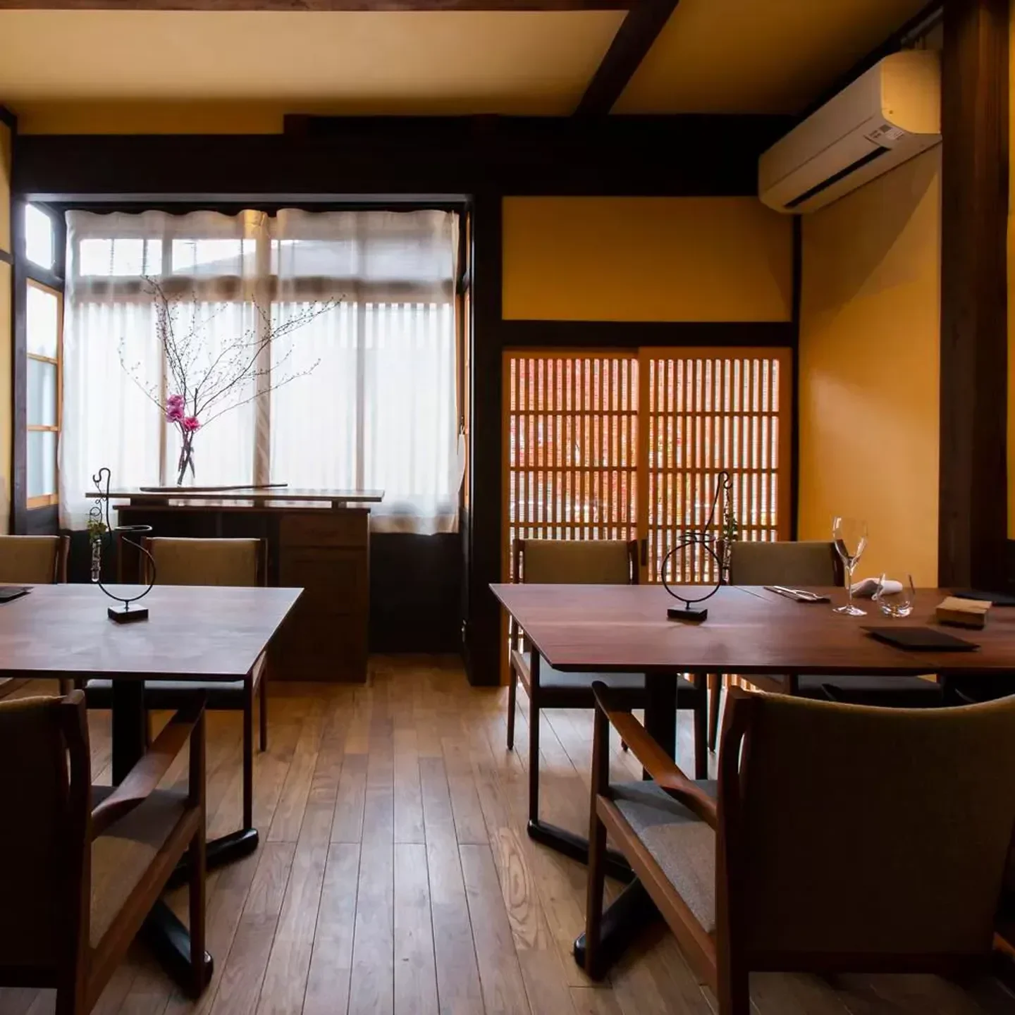 Interior of Bini restaurant in Kyoto, featuring wooden tables and Japanese-style design