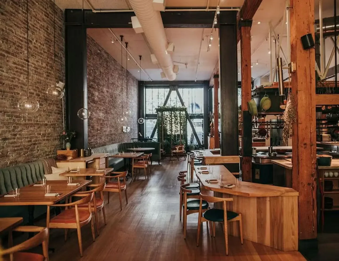 Interior of Birdsong restaurant in San Francisco with exposed brick and wooden accents.