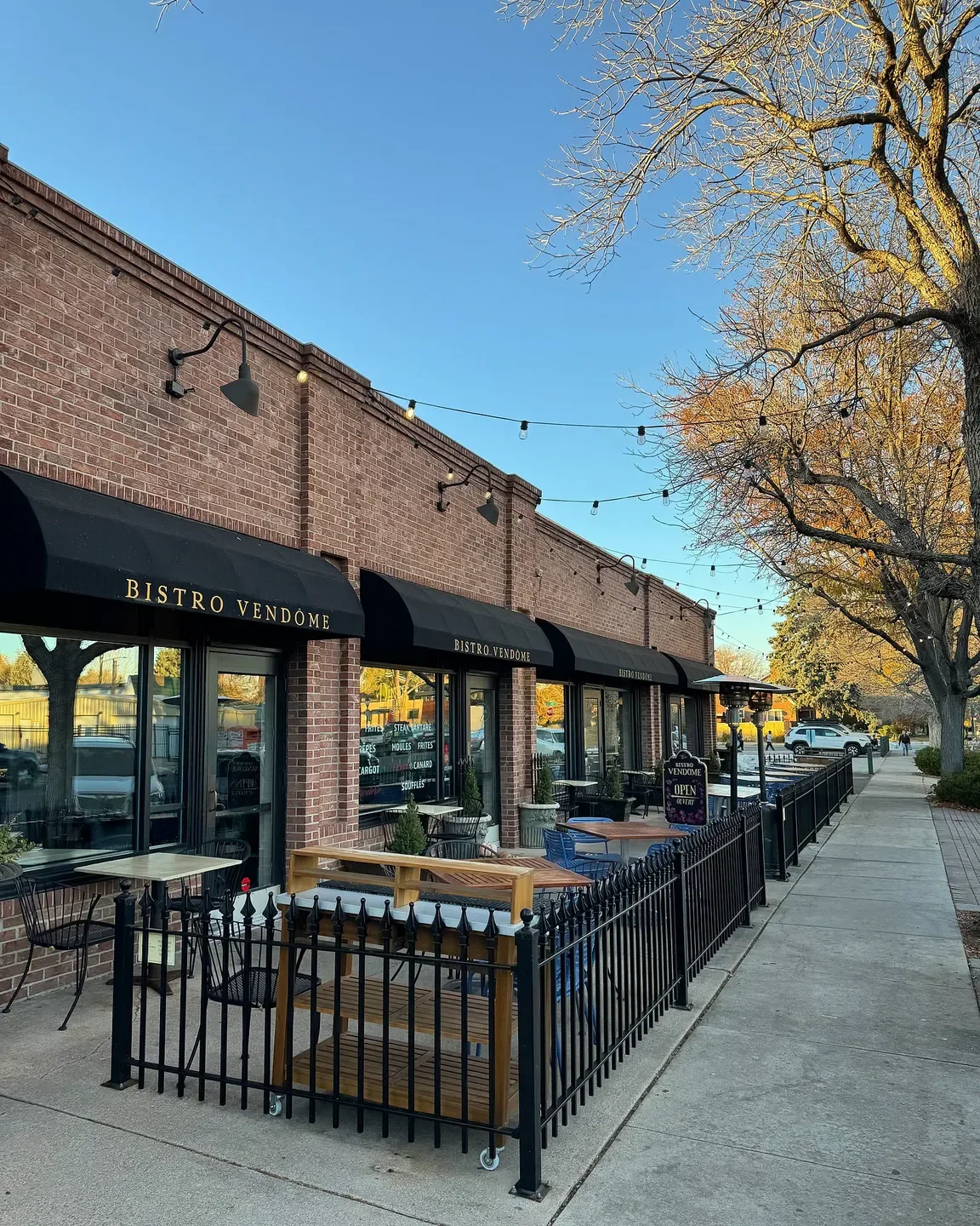 Bistro Vendôme restaurant exterior in Denver with outdoor seating and brick facade.