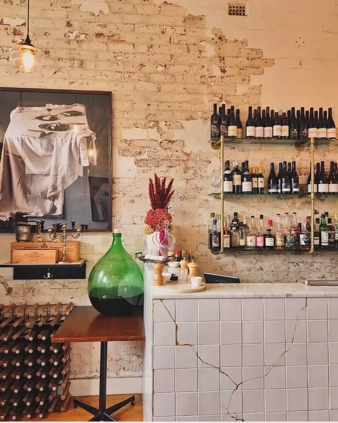 Interior of Bistrot Plume Geelong, showcasing bar, wine, and decorative details.