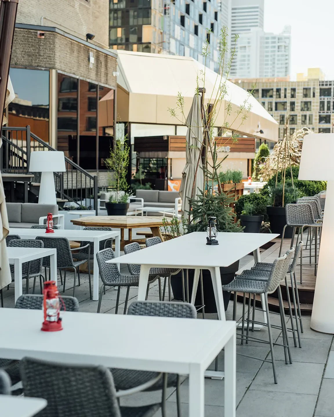 Outdoor dining area at Bivouac restaurant in Montreal, featuring modern furniture and city views.