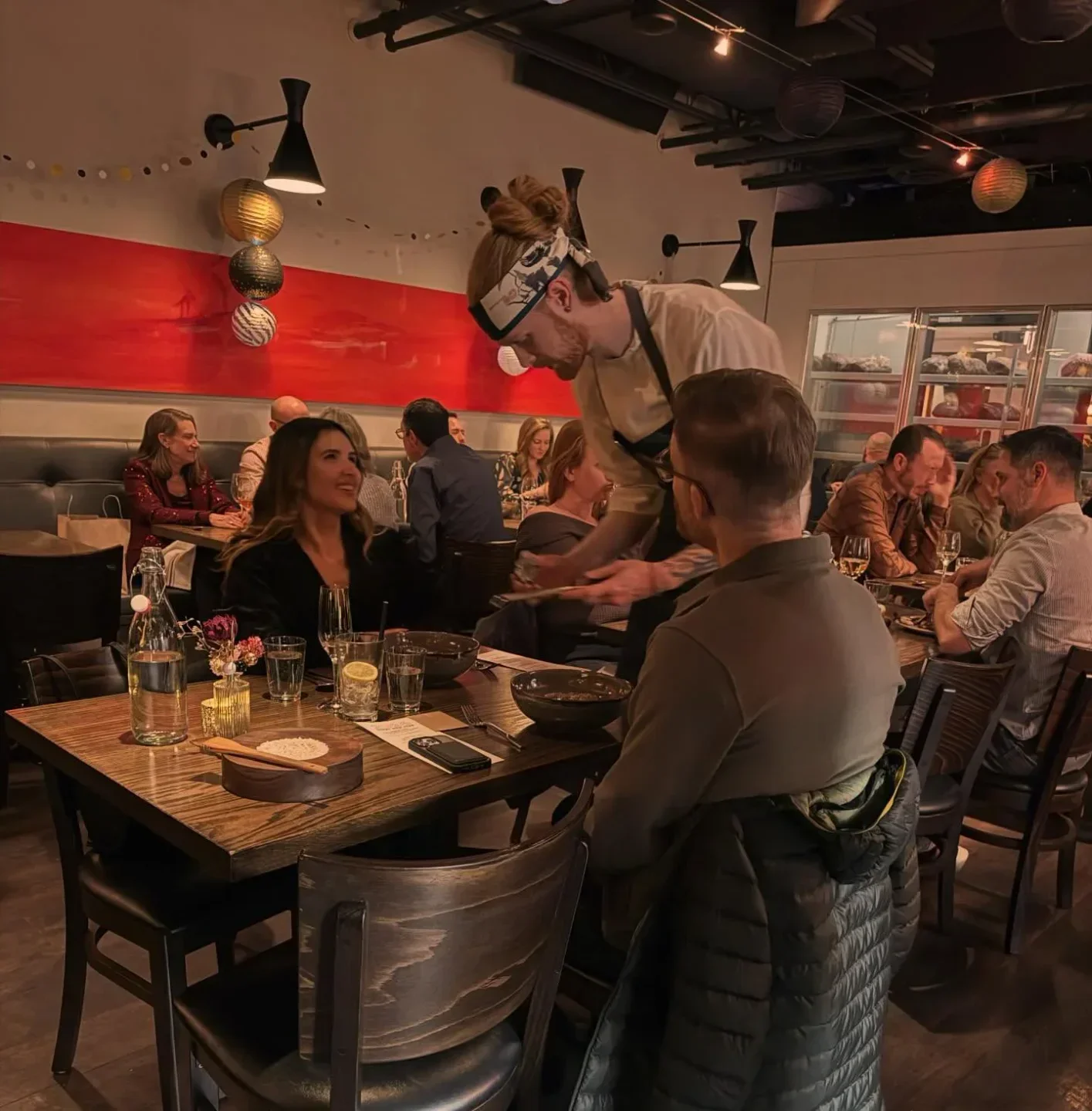 Blackbelly Market in Boulder, CO, with a server attending to a table.