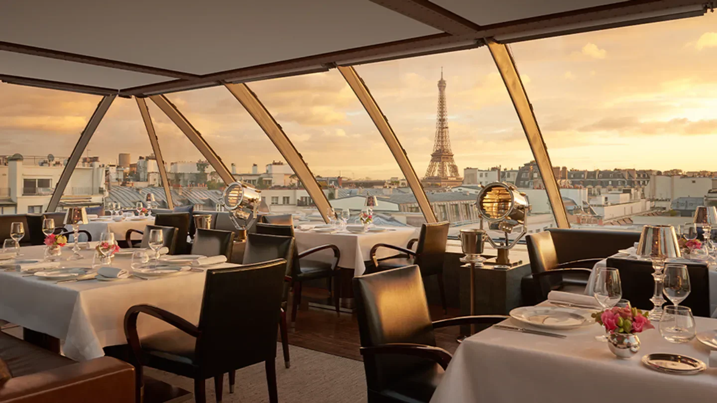 Elegant dining at Blanc restaurant in Paris with Eiffel Tower view at sunset