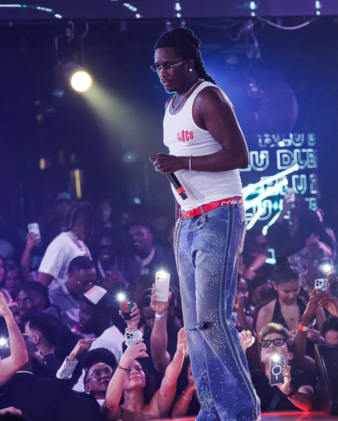 Concert at Blu Dubai nightclub featuring a performer on stage in front of a crowd.