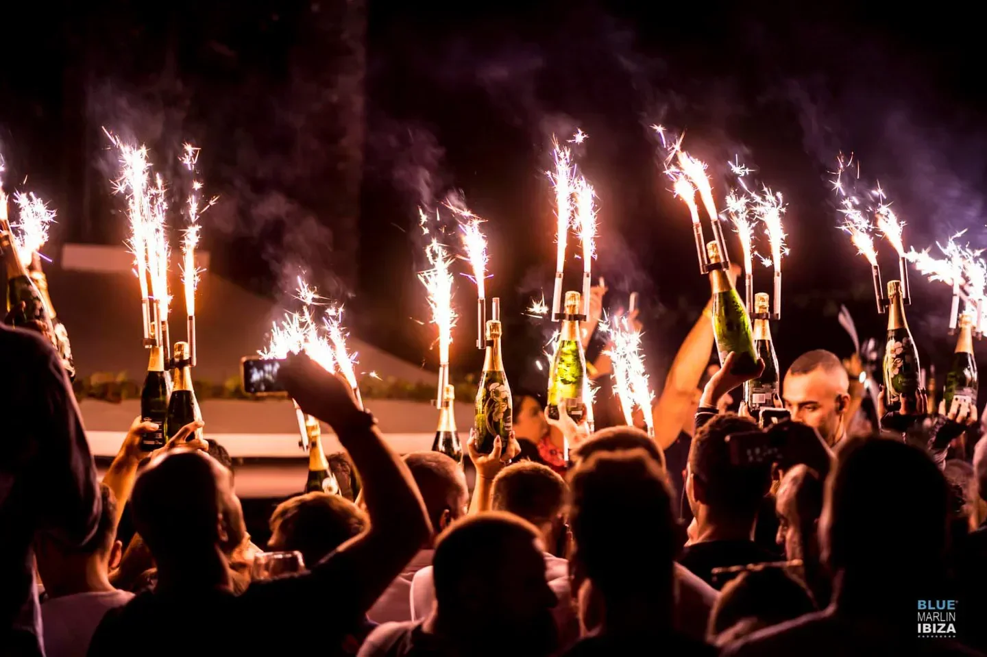 Champagne bottles with sparklers at Blue Marlin Ibiza beach club celebration.