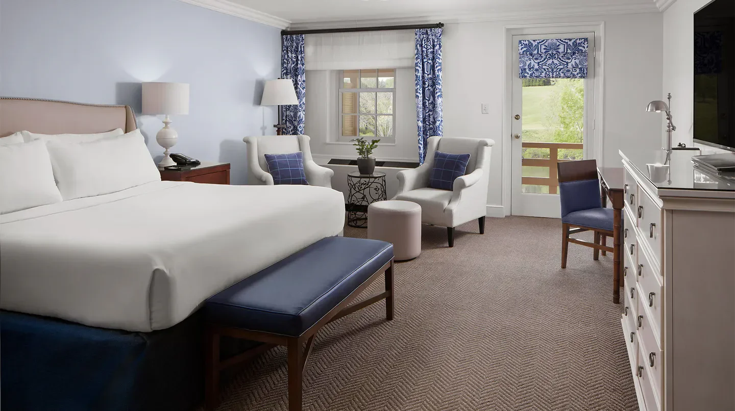 Cozy hotel room at Boar's Head Resort in Charlottesville, featuring comfortable seating and a view.