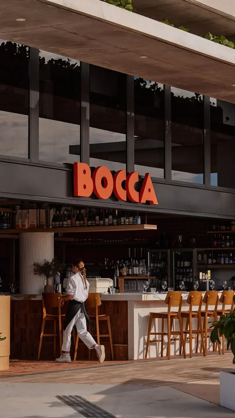 Bocca Italian restaurant on the Sunshine Coast, with a server walking by the bar.
