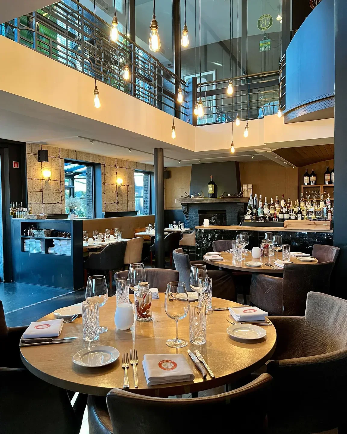 Interior of Boecherie restaurant in Antwerp, featuring elegant table settings and decor.