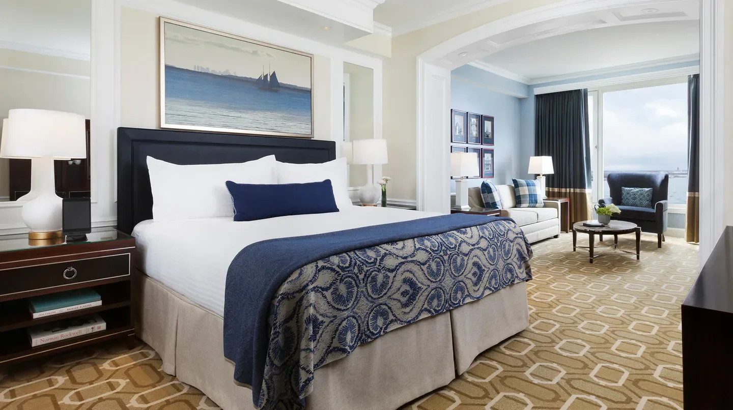 Elegant bedroom at the Boston Harbor Hotel in Boston, featuring water views and stylish decor.