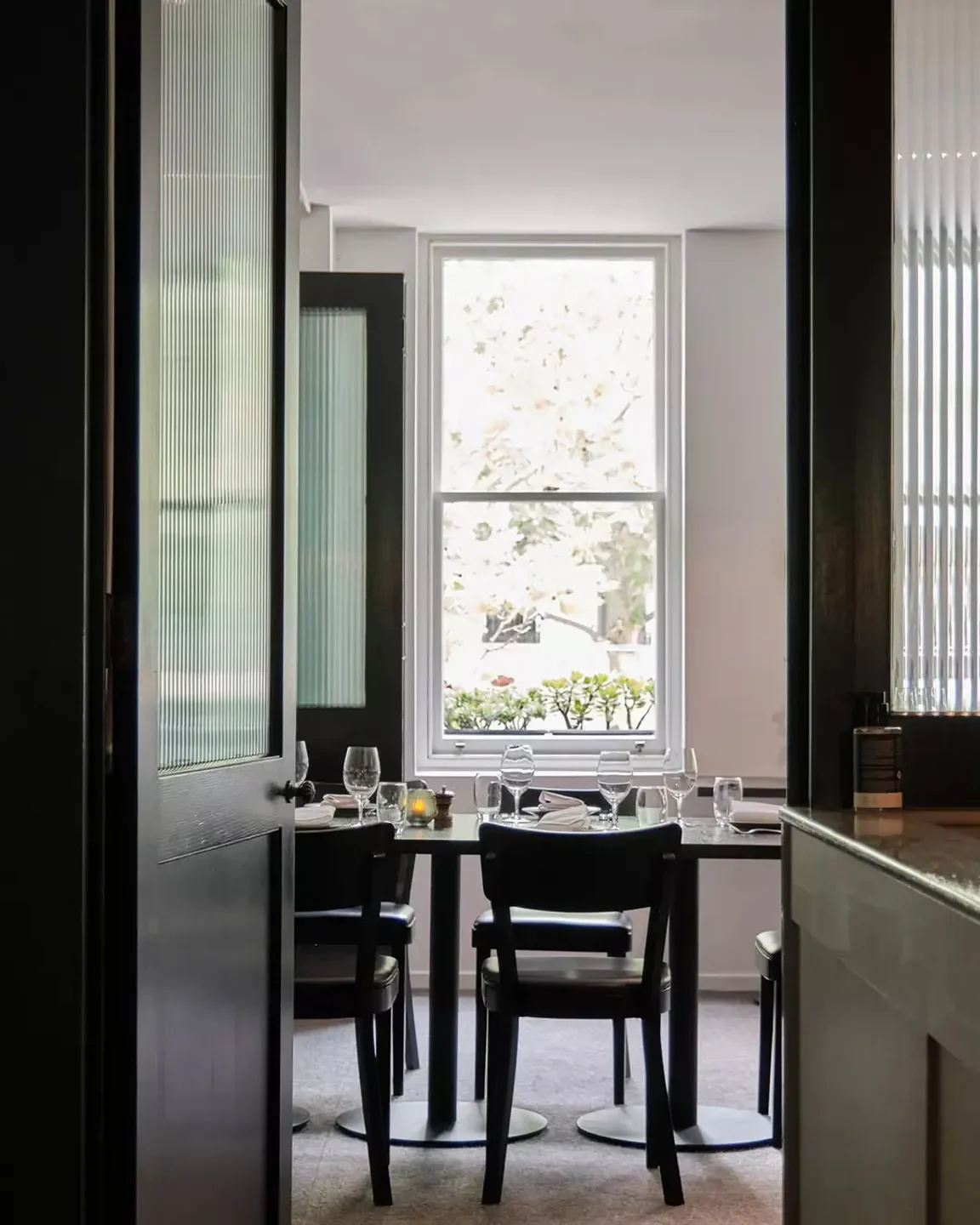 Interior dining scene at Bottega Restaurant in Melbourne, featuring elegant table setting.