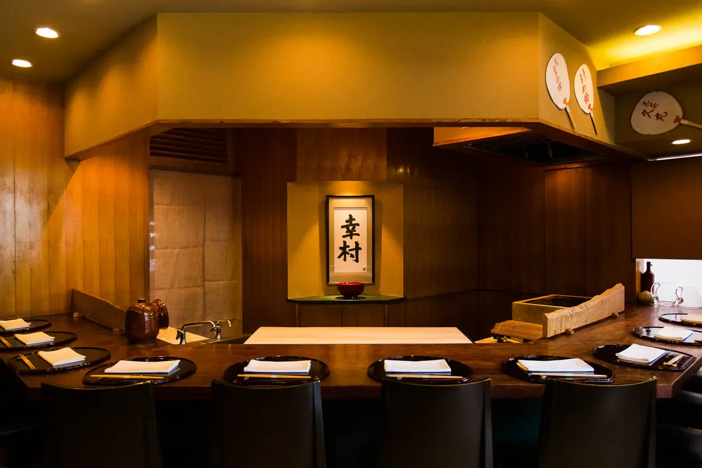 Interior dining at BOTTEGA restaurant in Tokyo, featuring traditional Japanese decor and calligraphy.