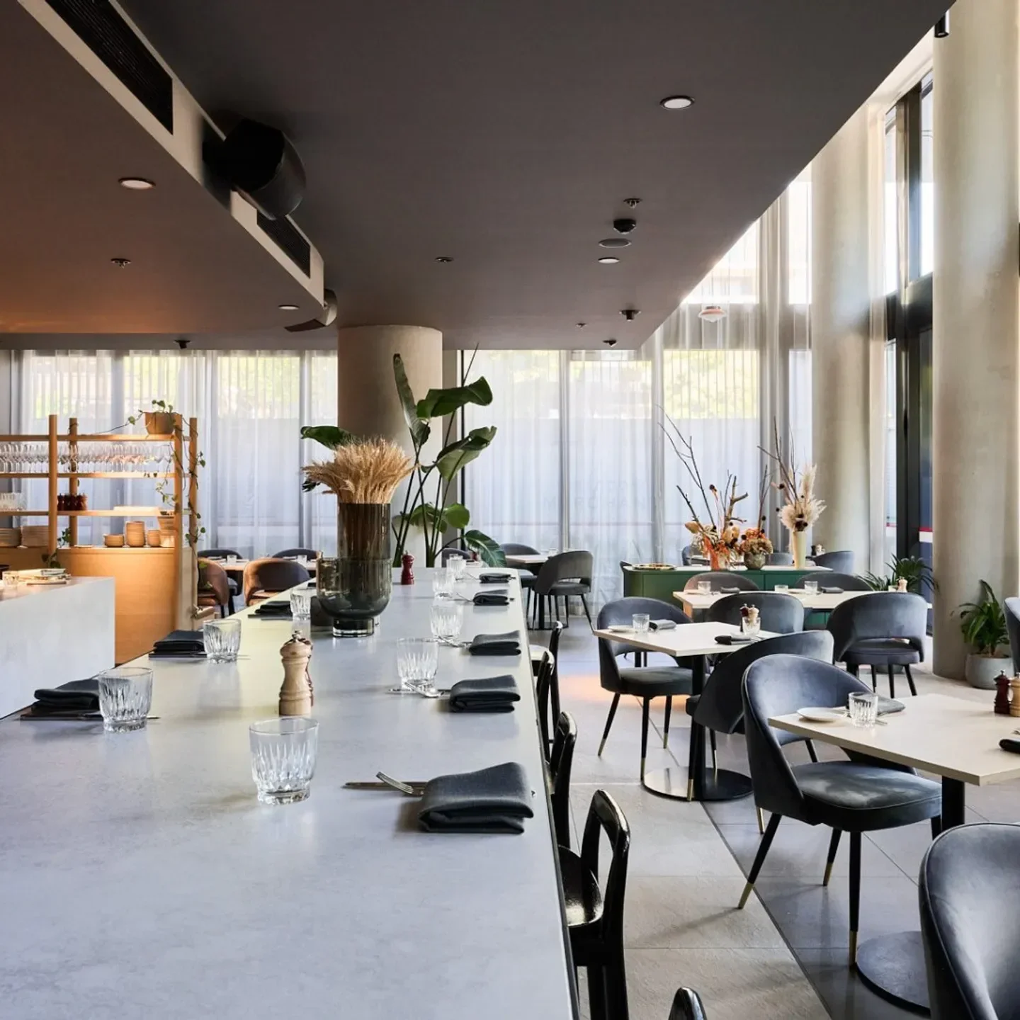 Modern interior of Braddon Merchant restaurant in Canberra, featuring stylish tables and decor