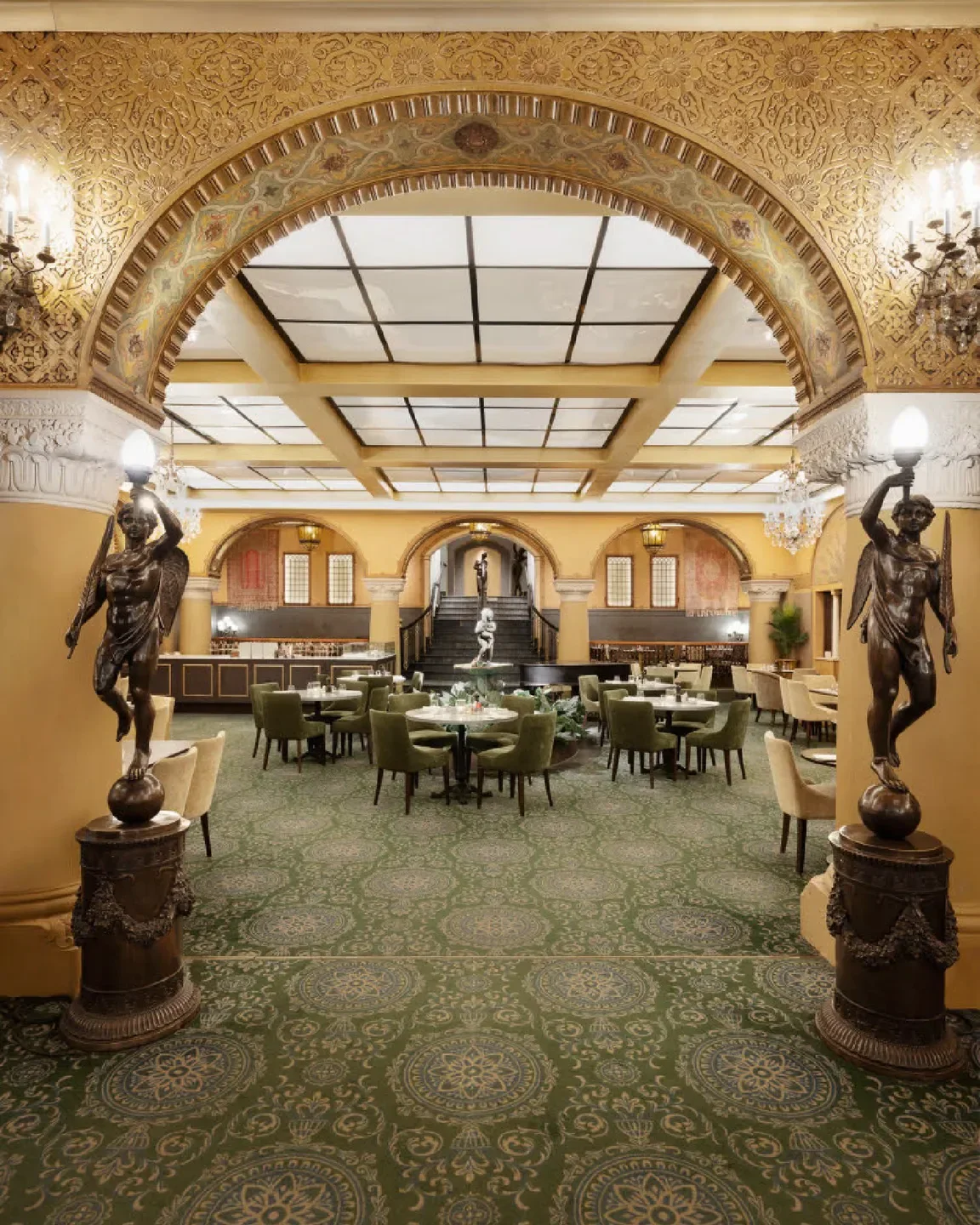 Elegant dining room interior at Bristol Grill in Oslo, featuring ornate architecture.