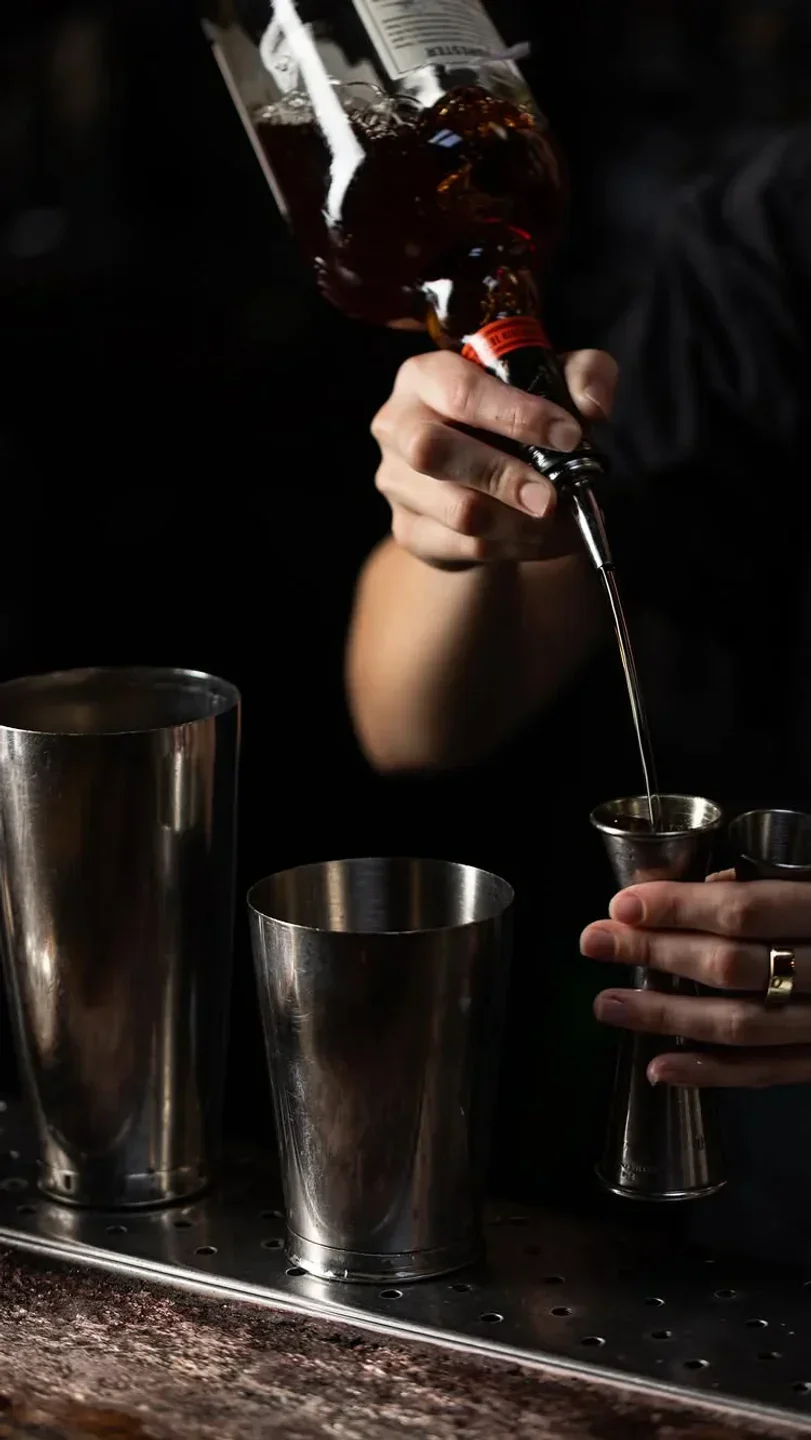 Broadway by Amar Santana in Orange County: bartender pouring a drink into a jigger.