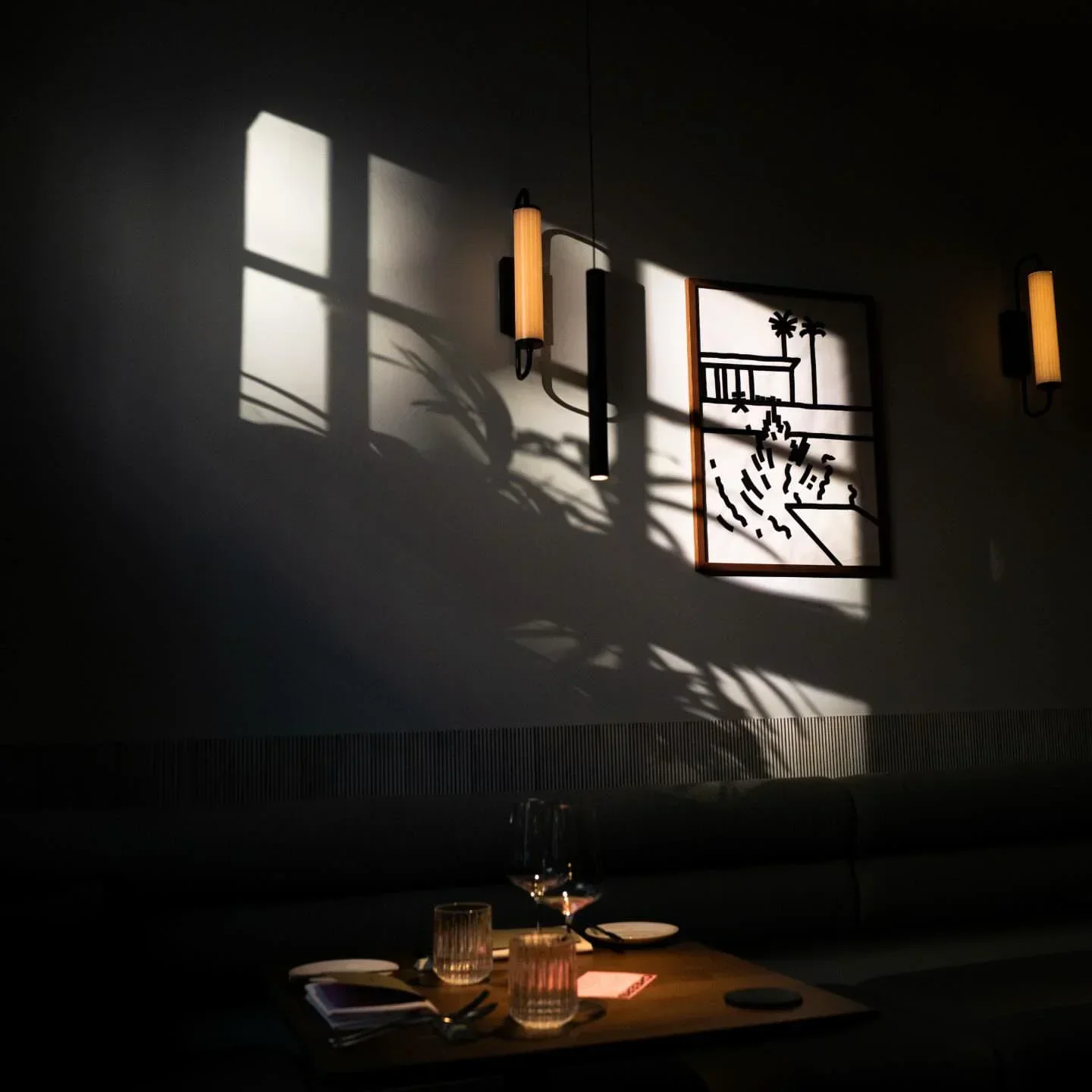 Interior of Brothers restaurant in Munich, featuring art and a dimly lit dining space.