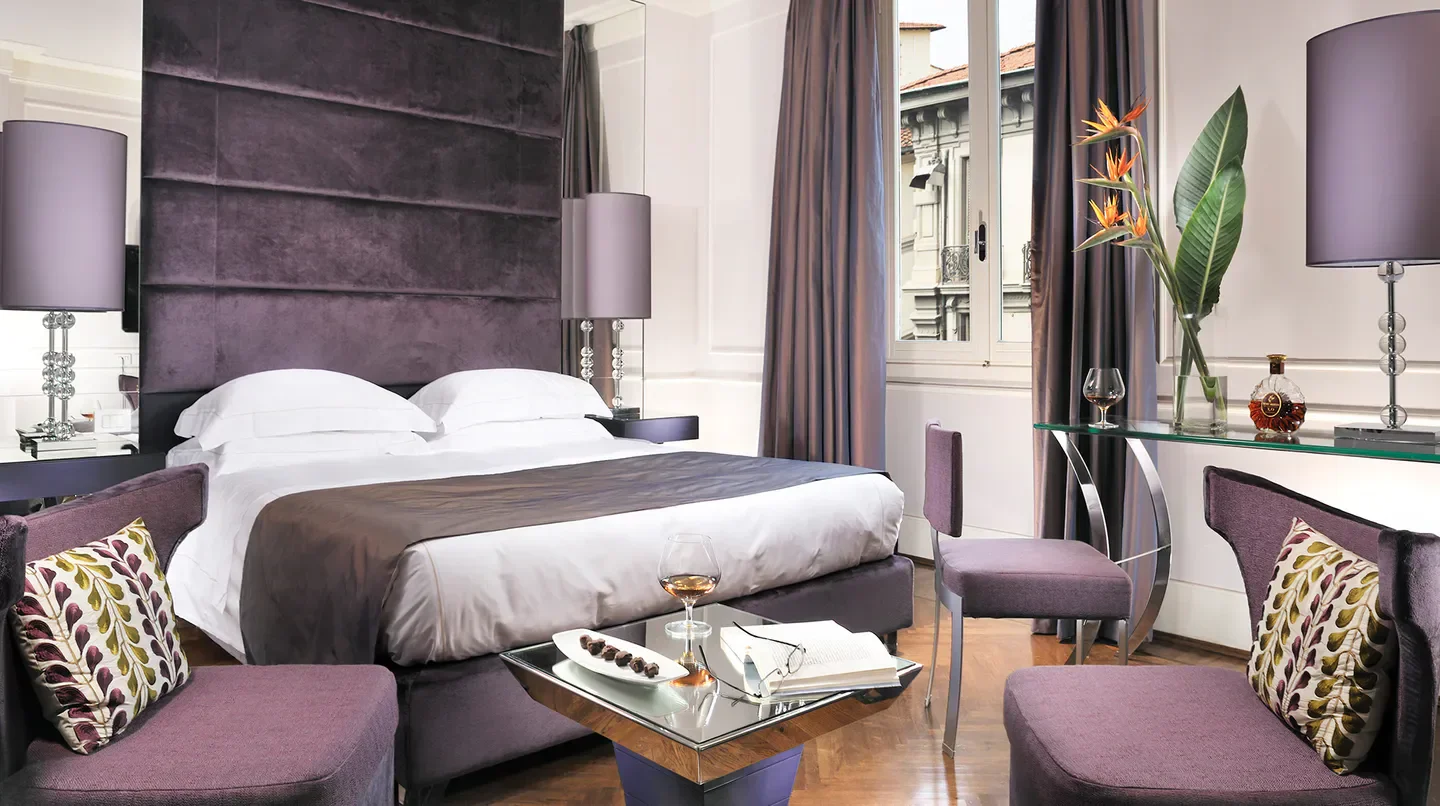 Elegant bedroom at Brunelleschi Hotel in Florence, featuring luxurious decor and design.