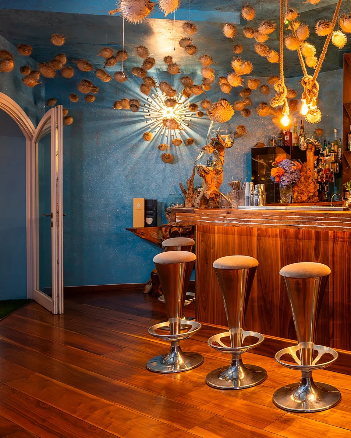 Bubble Bar & Bistrot Porto Cervo unique interior featuring pufferfish decor and stylish bar stools