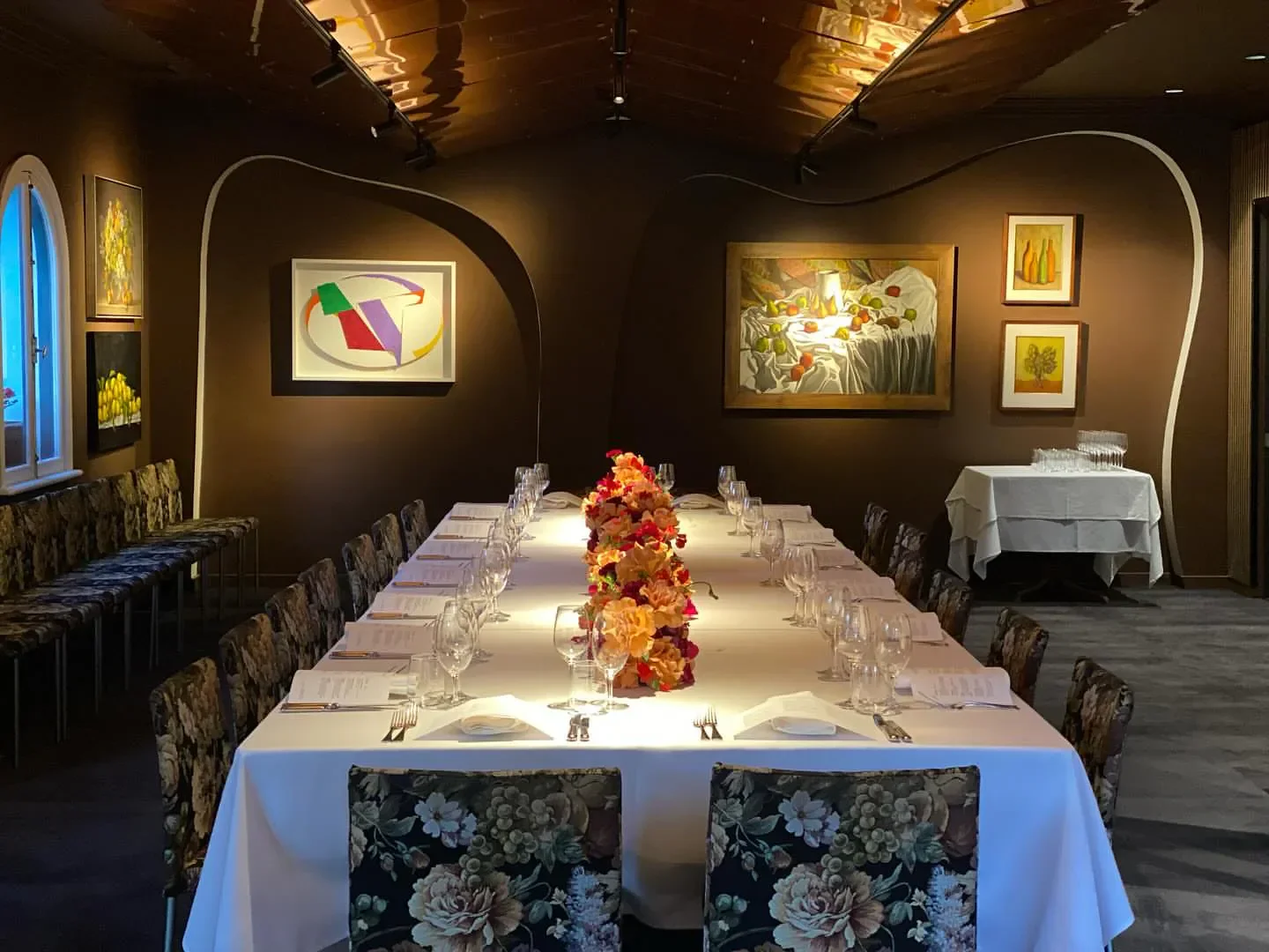 Elegant dining at Buon Ricordo Ristorante, Sydney, with floral chairs and art