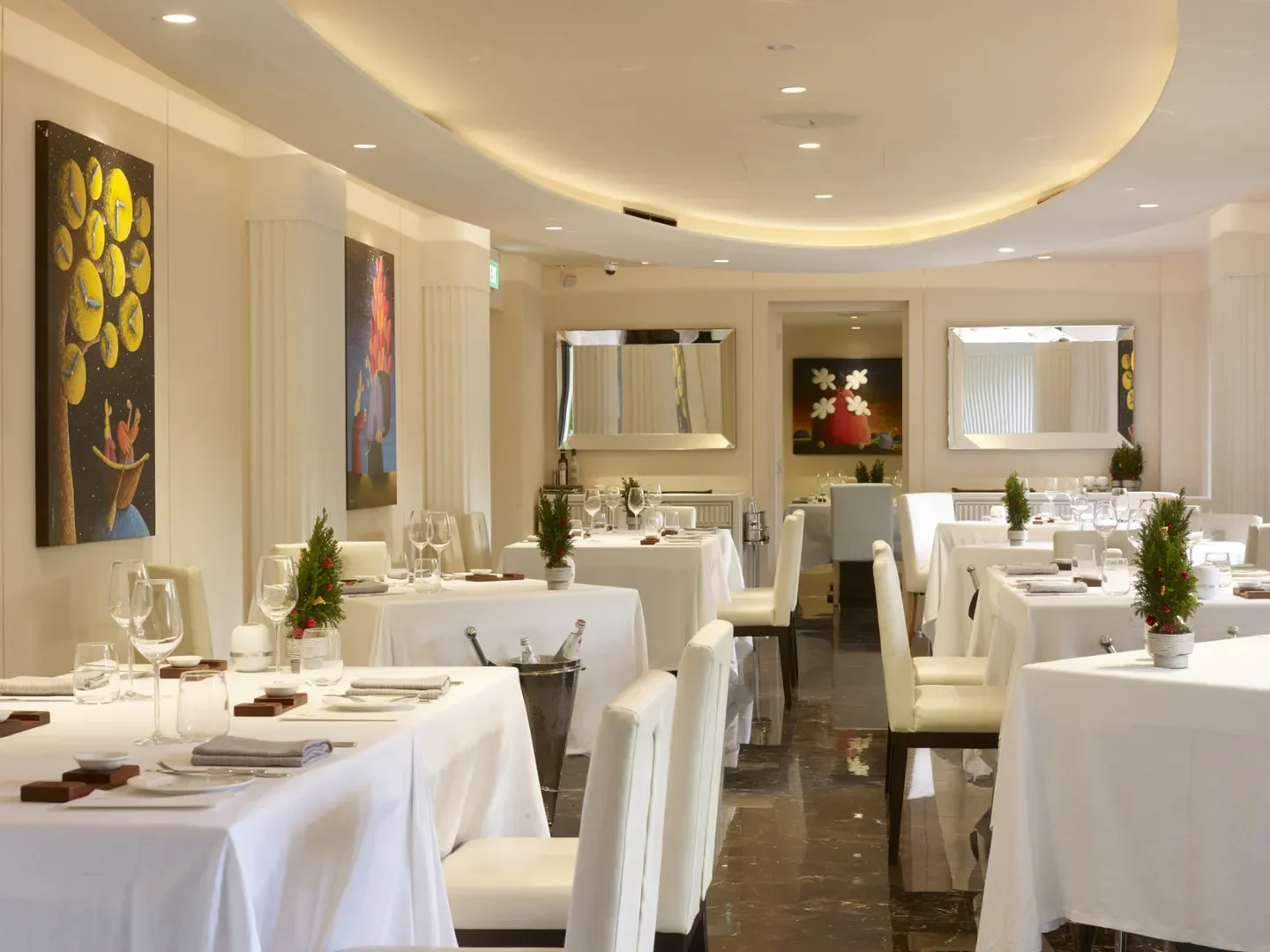 Elegant dining room interior at Buona Terra restaurant in Singapore, featuring art and tables