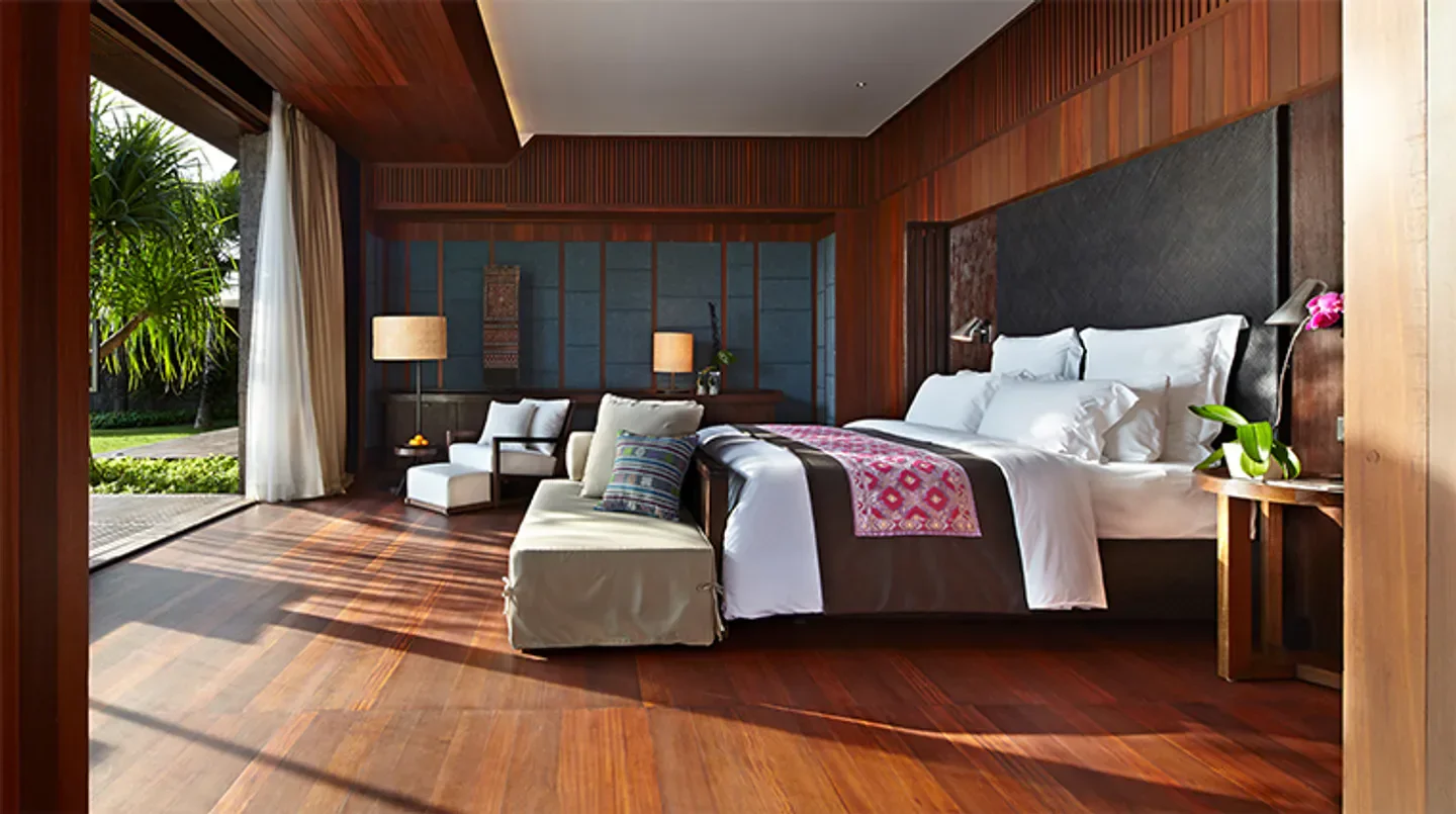 Luxury bedroom at Bvlgari Resort Bali with wooden floor and garden view