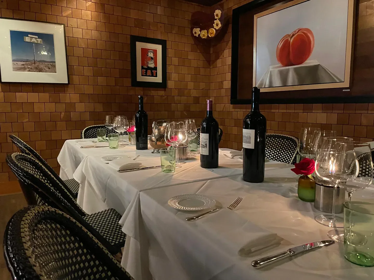 Cozy dining setting at C29 restaurant in Napa Valley, featuring wine and artwork.