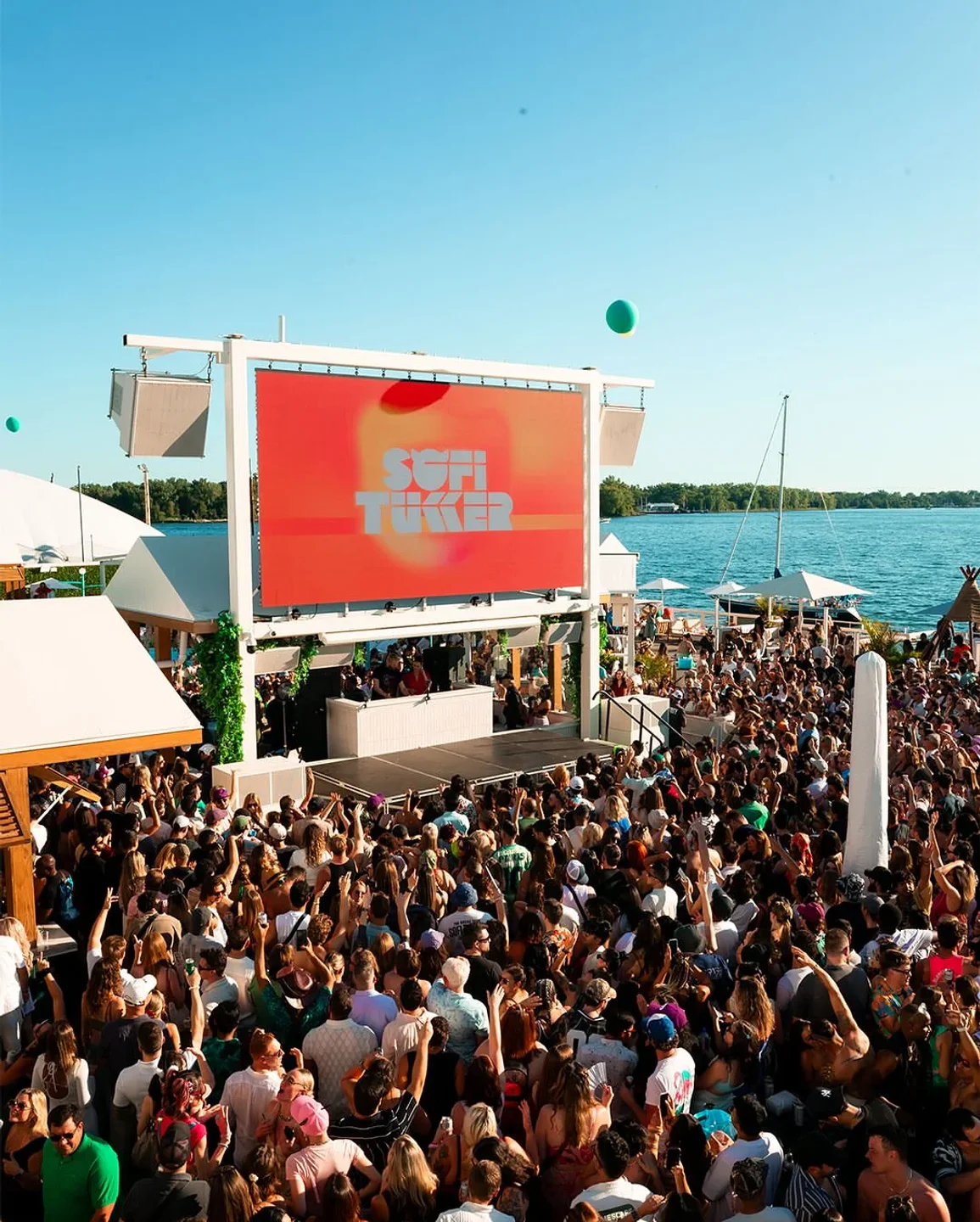 Crowd at Cabana Pool Bar in Toronto during a live performance, enjoying the summer party atmosphere.