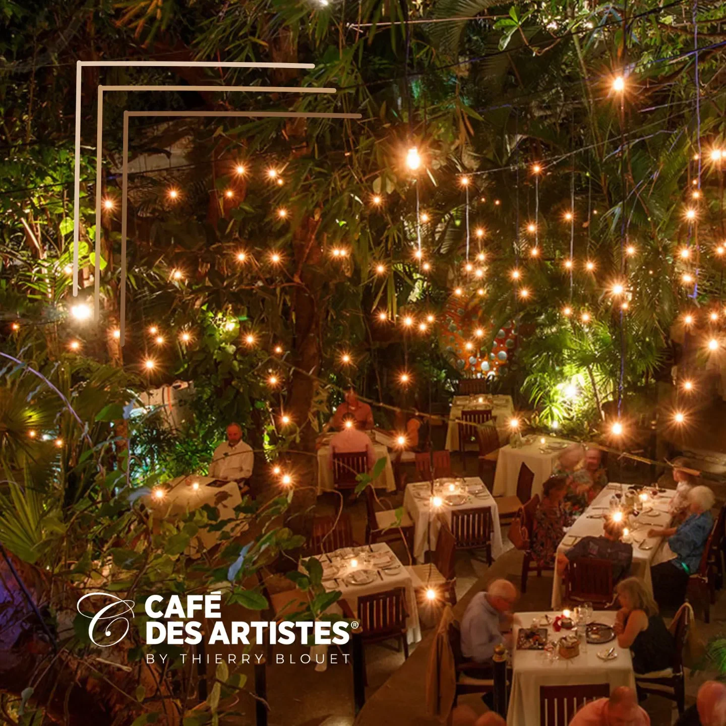 Romantic outdoor dining at Café des Artistes in Puerto Vallarta, glowing string lights.