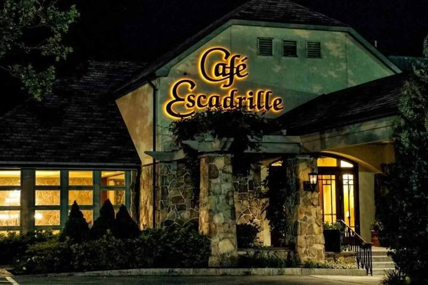 Cafe Escadrille restaurant in Boston at night, illuminated sign and entrance.